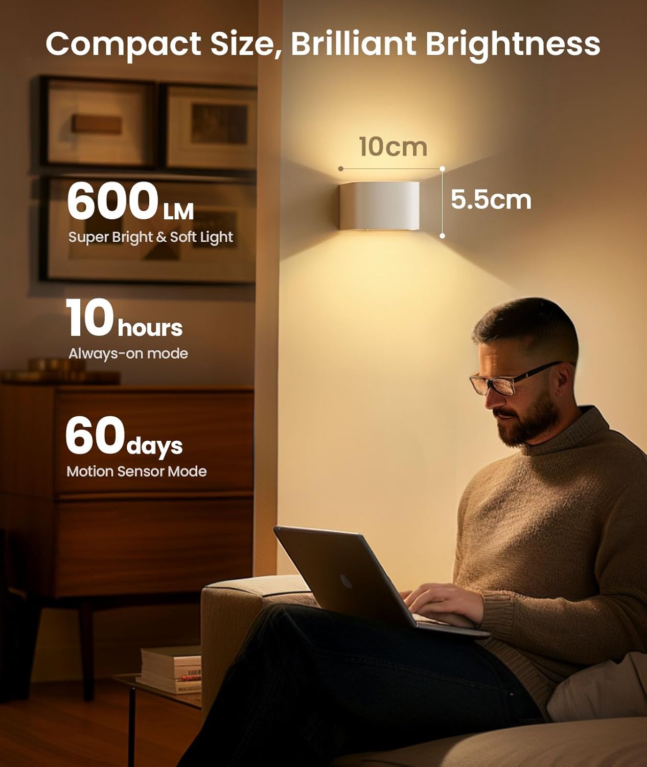 Person using a laptop in a dimly lit room with a wall light illuminating the area.