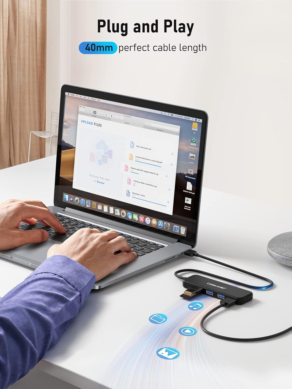 Person using a laptop with a USB hub on a desk, emphasizing 'Plug and Play' feature.