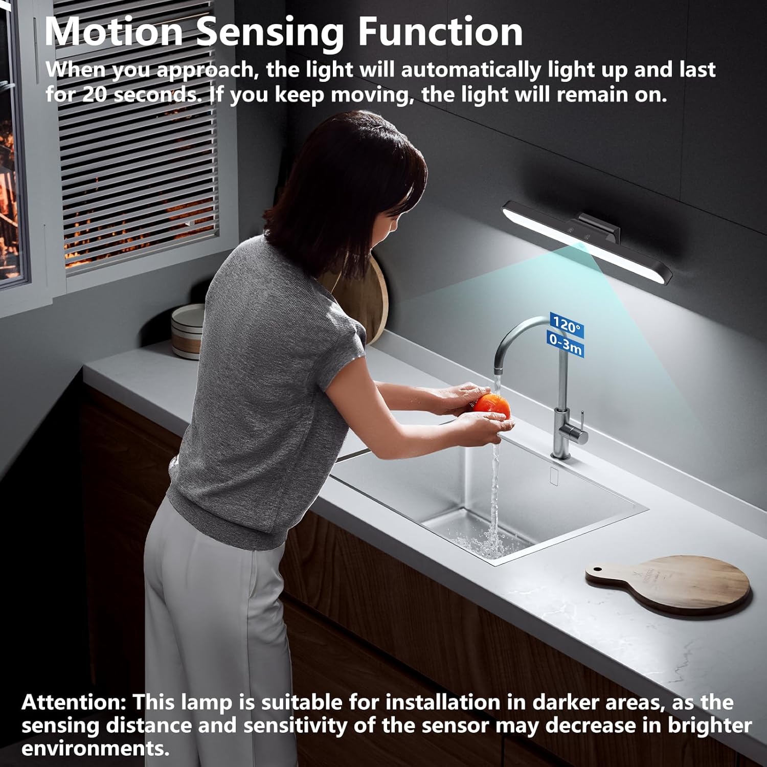 Person washing hands under a motion-sensing light in a kitchen.