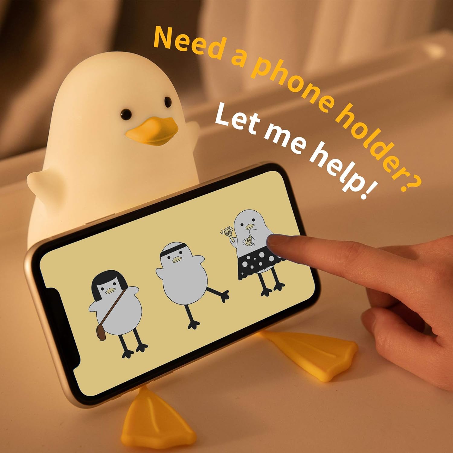 Phone holder shaped like a duck with cartoon penguins on a smartphone screen, text 'Need a phone holder? Let me help!'