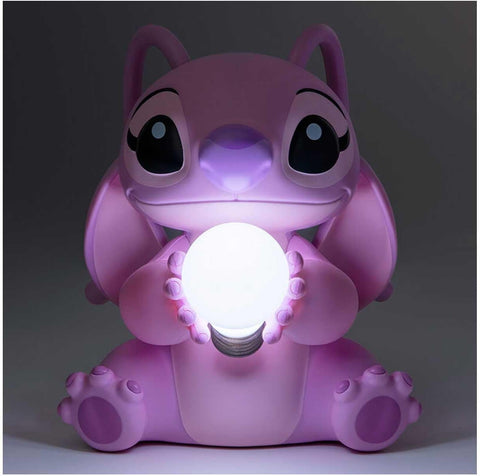 Pink cartoon-style lamp with a glowing light bulb on a dark background