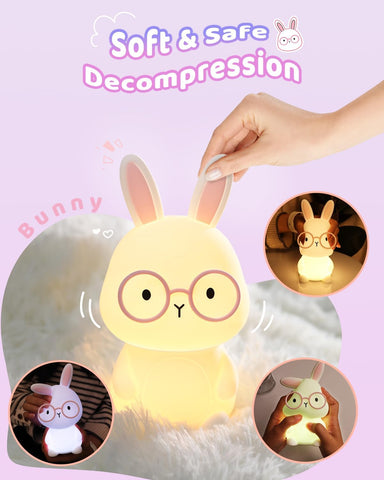 Plush bunny with glasses held by a hand on a light purple background, with 'Soft & Safe Decompression' text above.