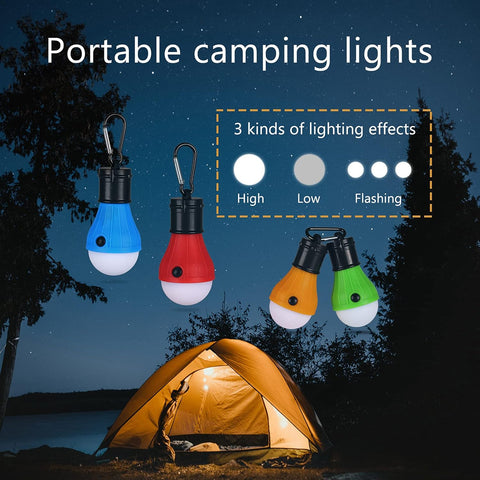 Portable camping lights with different lighting effects near a tent at night.