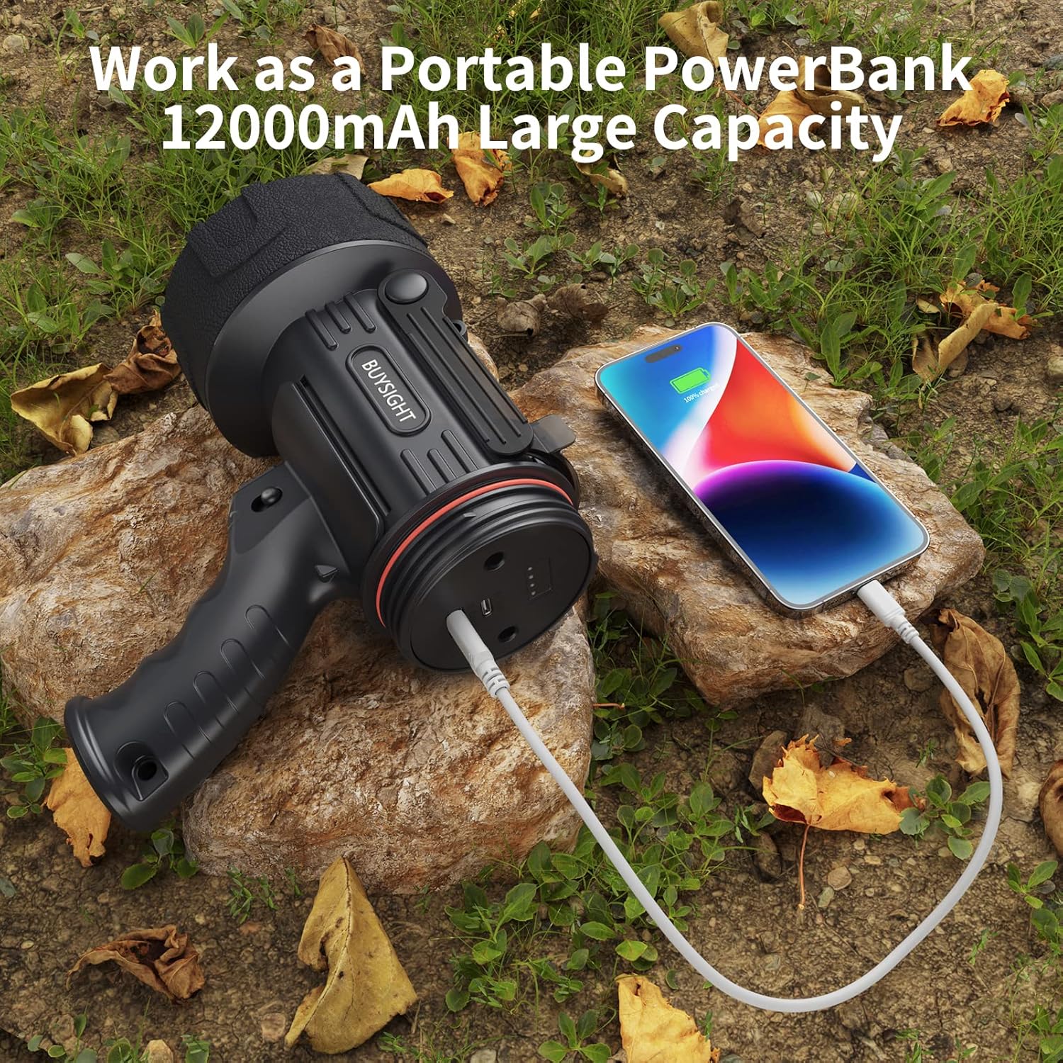 Portable power bank with a phone on a rock outdoors
