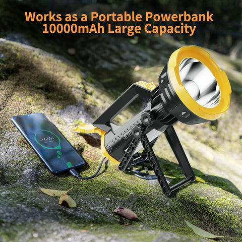Portable power bank with flashlight charging a smartphone on a natural background