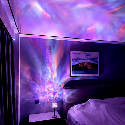 Room with colorful light display on ceiling and wall, bed in foreground