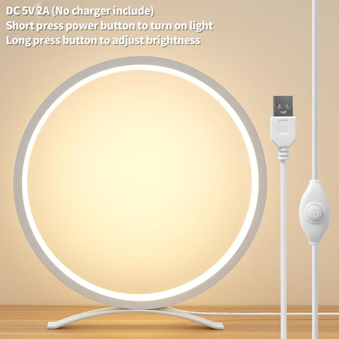 Round LED light with USB cable on a beige background