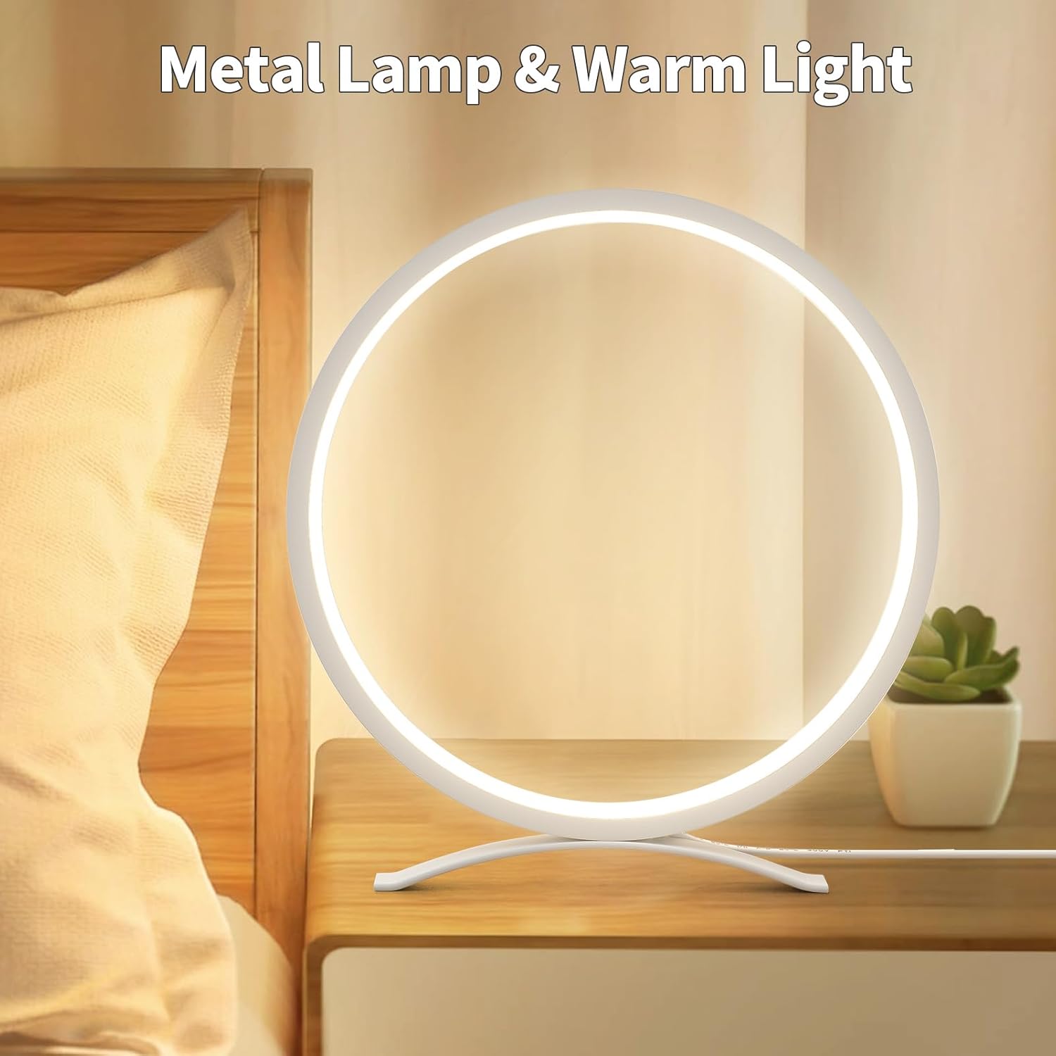 Round metal lamp with warm light on a wooden surface next to a bed