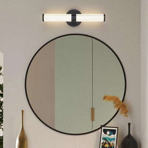 Round mirror with black frame on a wall with decorative elements