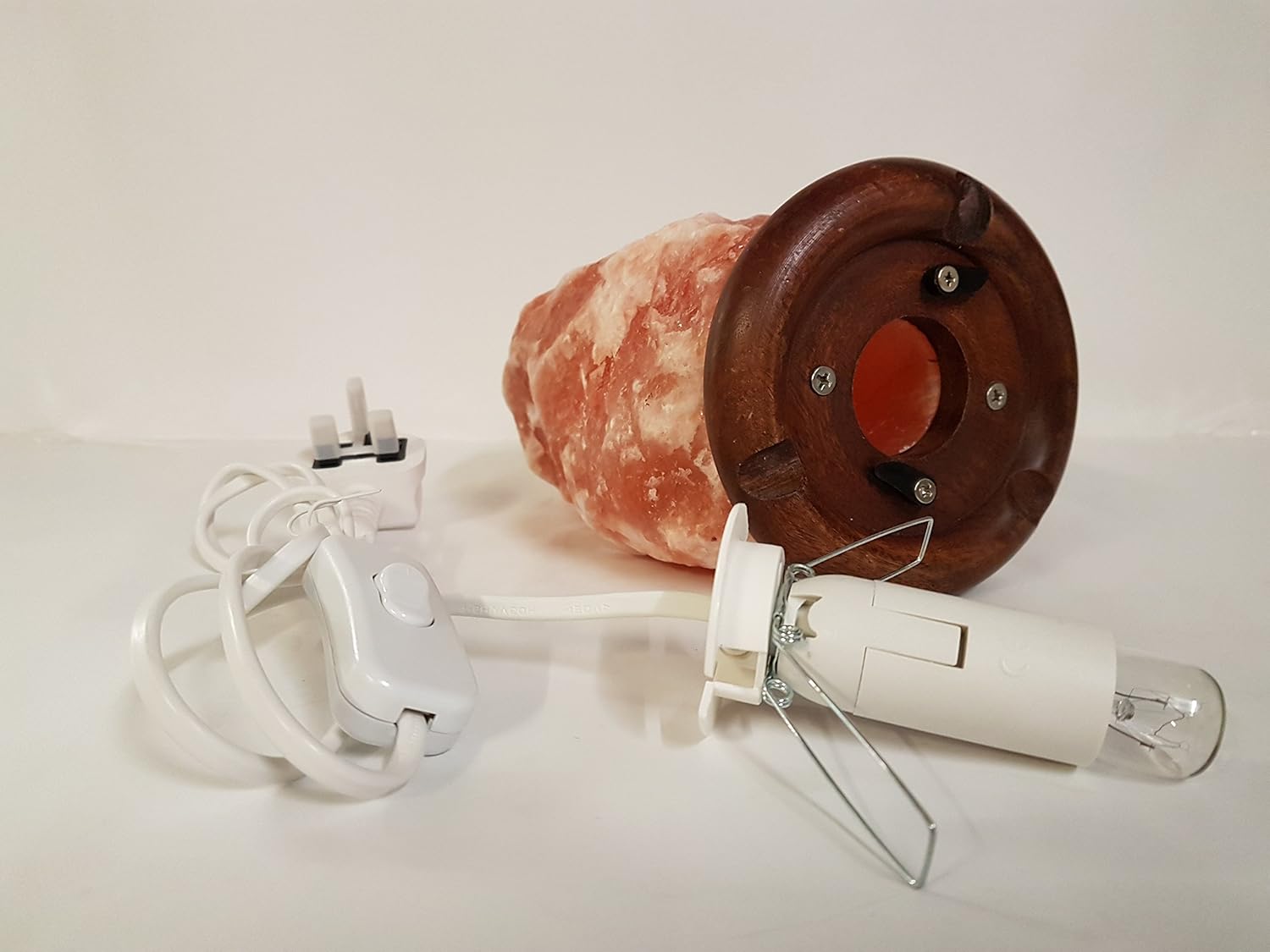 Salon head with wooden base, electrical plug, and light bulb on a white background