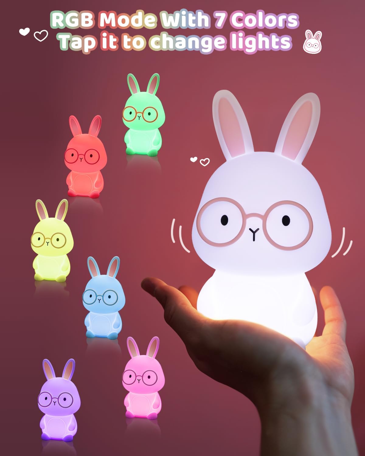 Set of colorful rabbit-shaped night lights with a hand interacting with one, on a dark background.