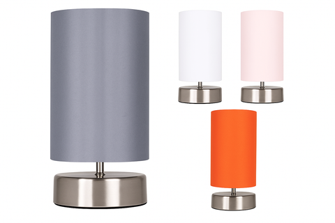 Set of four table lamps with different colored shades on a white background