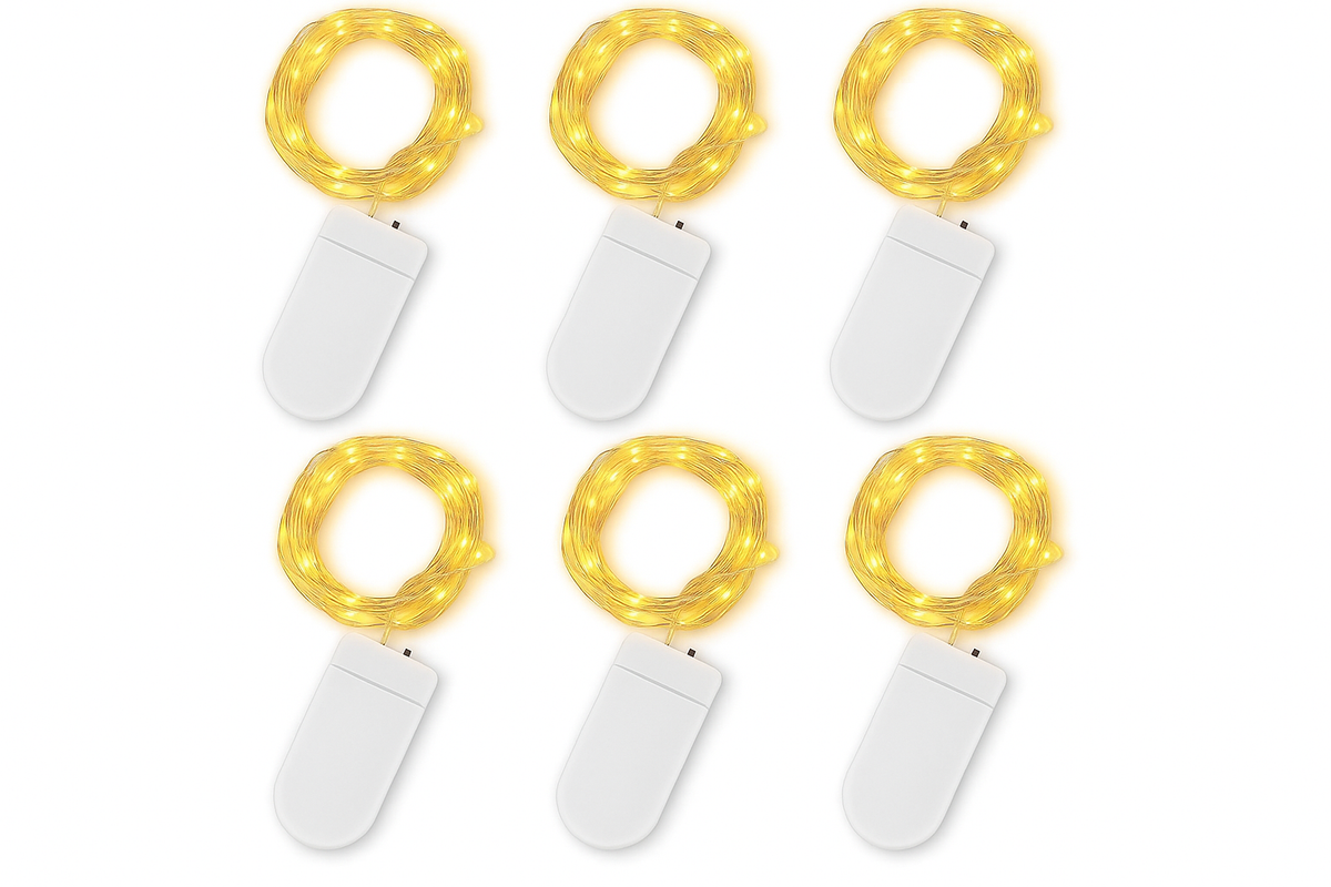 Set of six small string lights with white bases on a white background