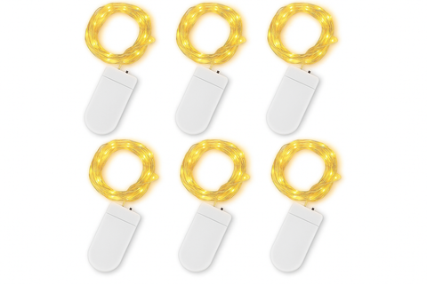 Set of six small string lights with white bases on a white background