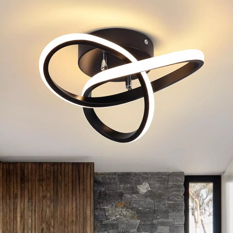 Modern ceiling light fixture with black and white design on a ceiling.