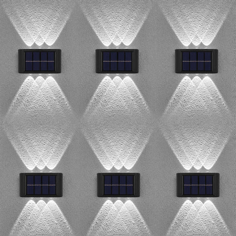 Six solar-powered wall lights on a textured gray wall.