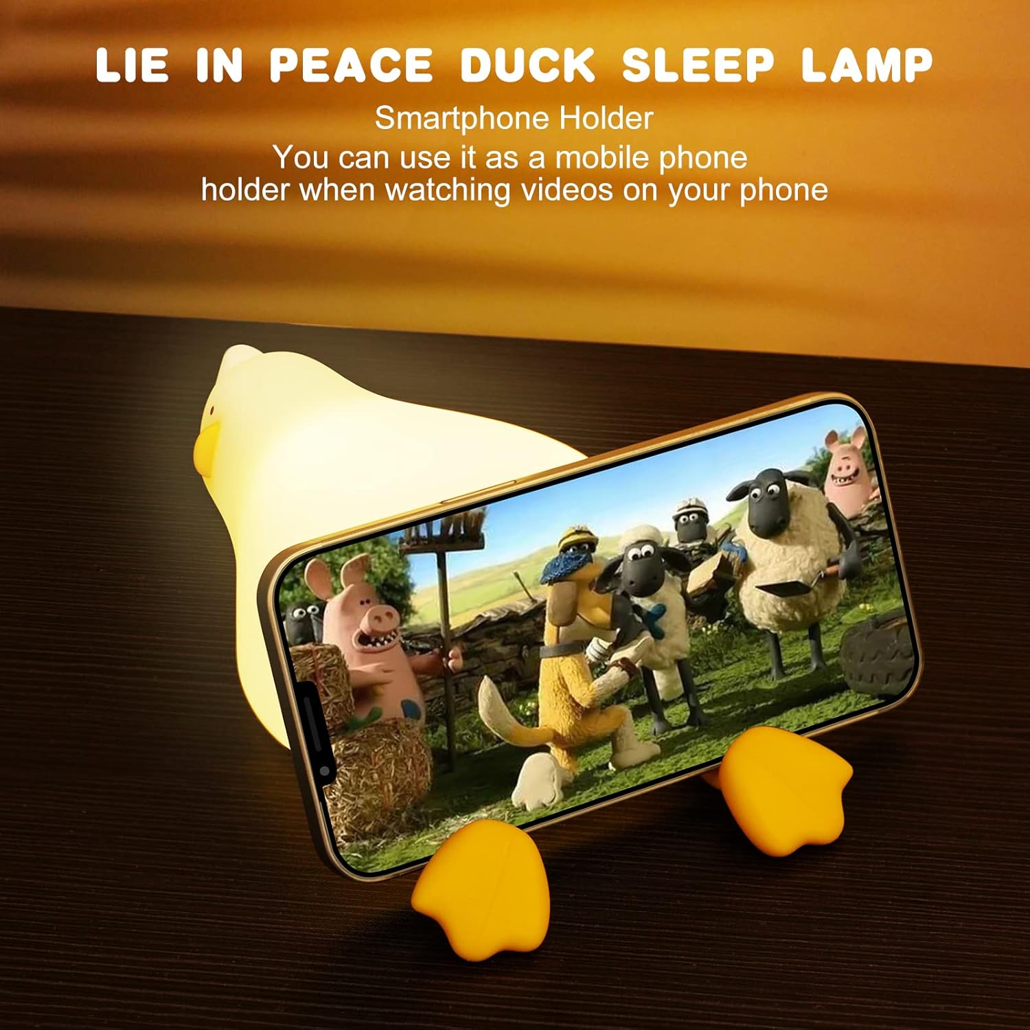 Smartphone holder with duck-shaped lamp displaying a cartoon scene on a phone screen.
