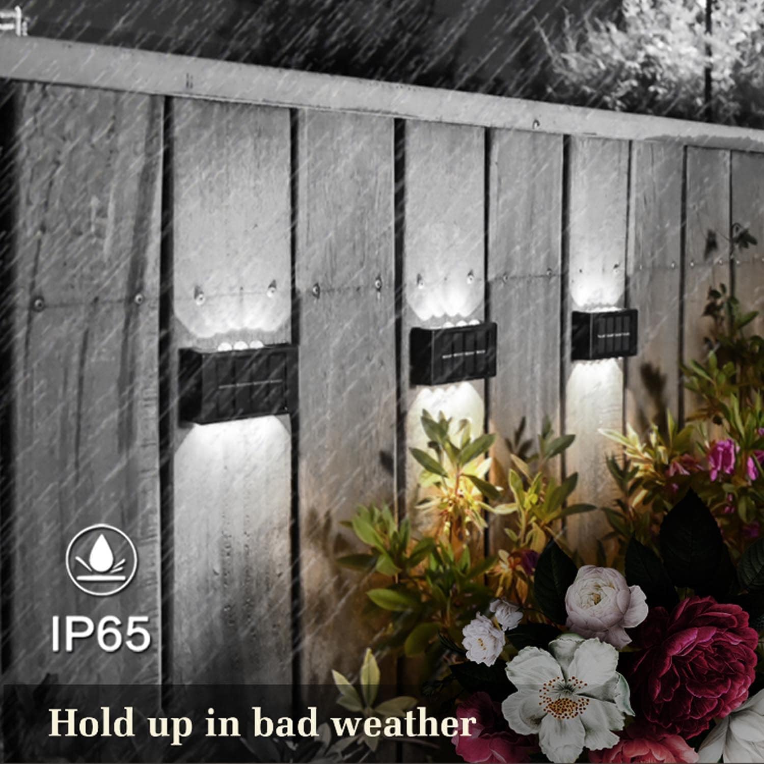 Solar-powered outdoor lights on a wooden fence with flowers in the foreground, featuring IP65 weather resistance rating.