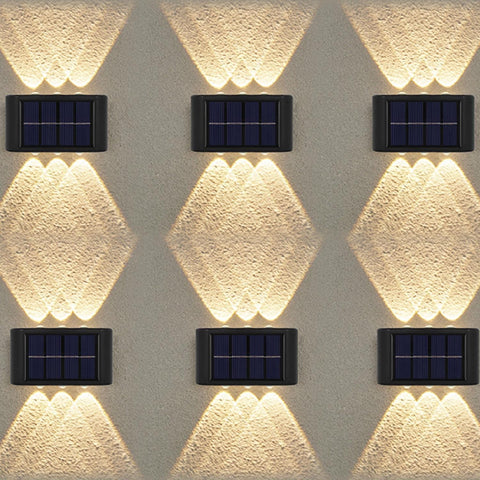Solar-powered wall lights on a textured wall