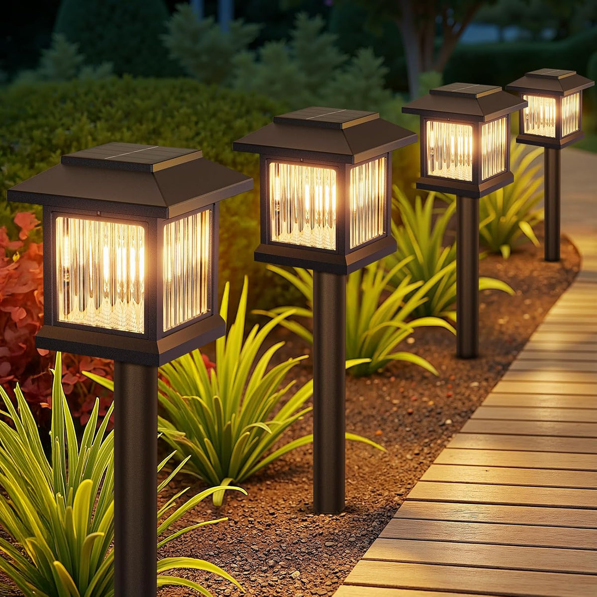 Solar garden lights on stakes illuminating a pathway with plants in the background