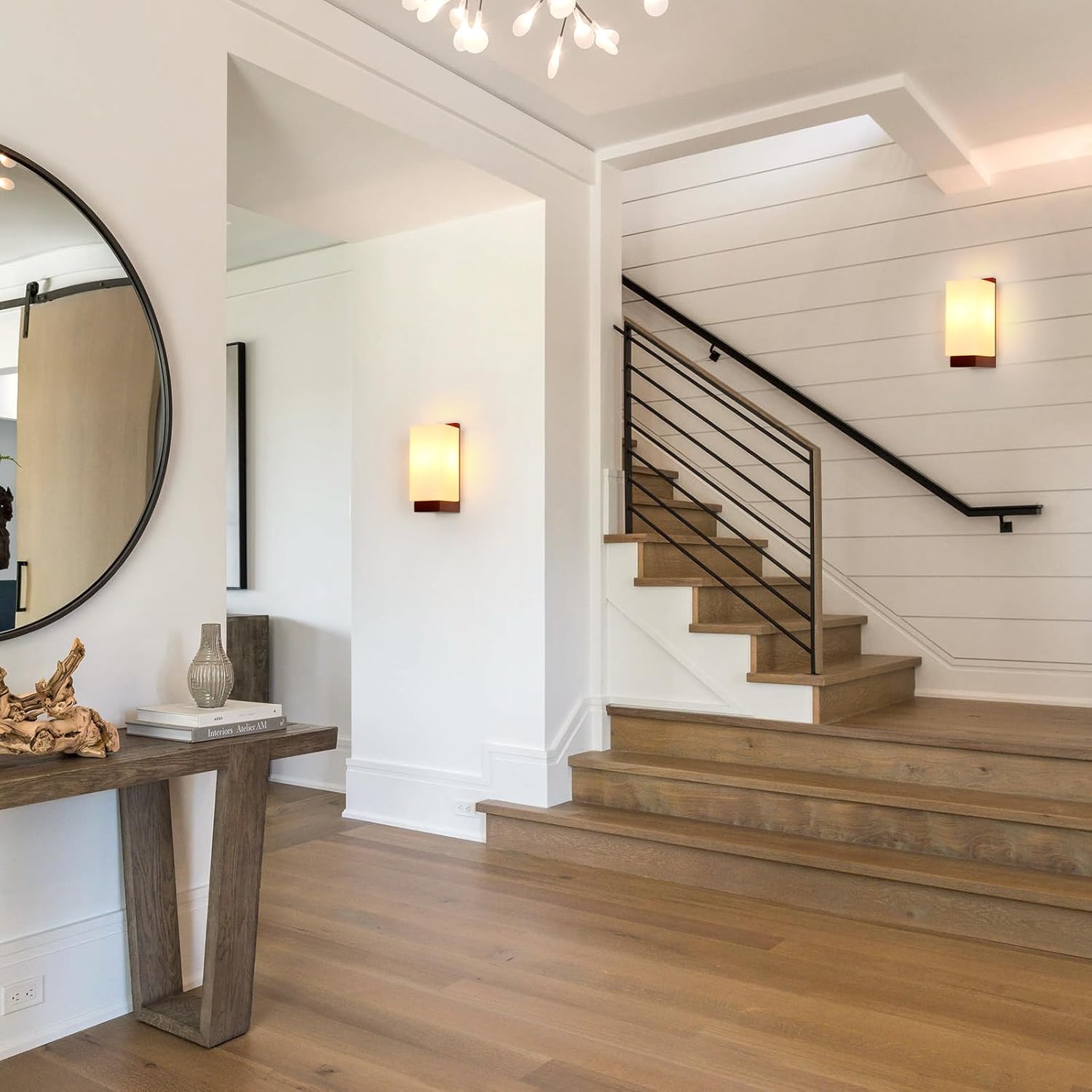 Staircase in a home with wooden flooring and a wall-mounted mirror.