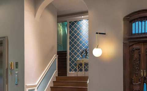 Staircase with a wall-mounted light fixture in a home interior.