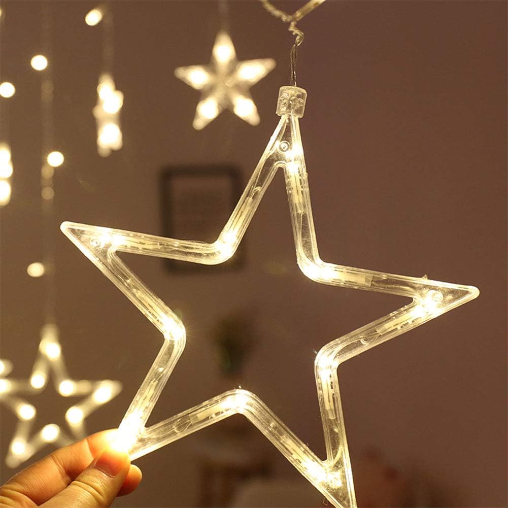 Star-shaped LED light held by a hand with more lights in the background