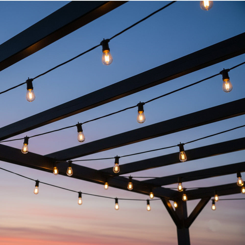 String lights hanging from a pergola against a twilight sky.