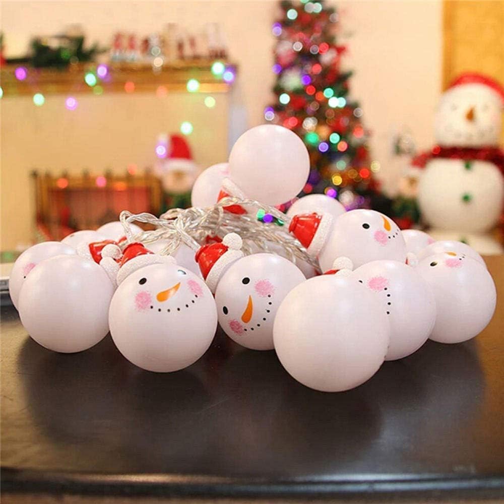String lights shaped like snowmen with a Christmas tree and snowman in the background.