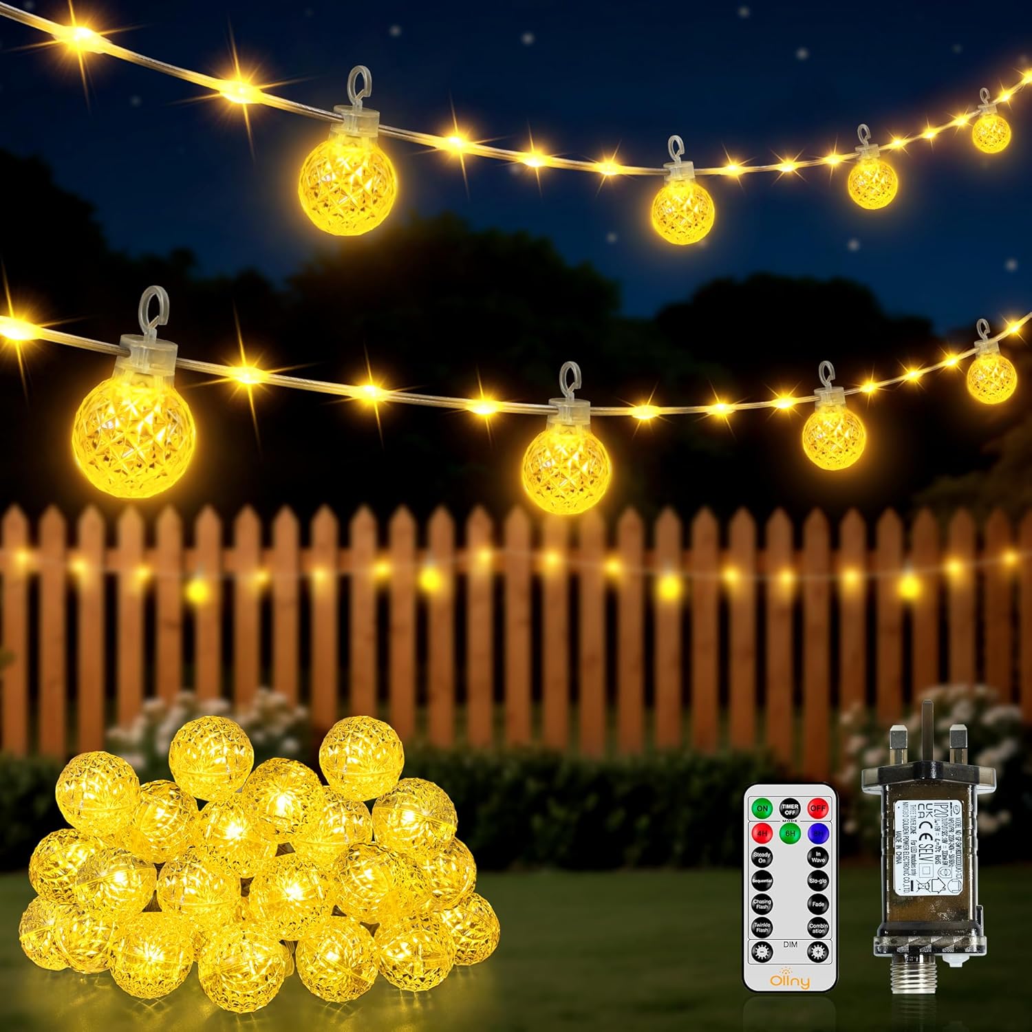 String lights with decorative bulbs, remote control, and power adapter against a night-time outdoor background.