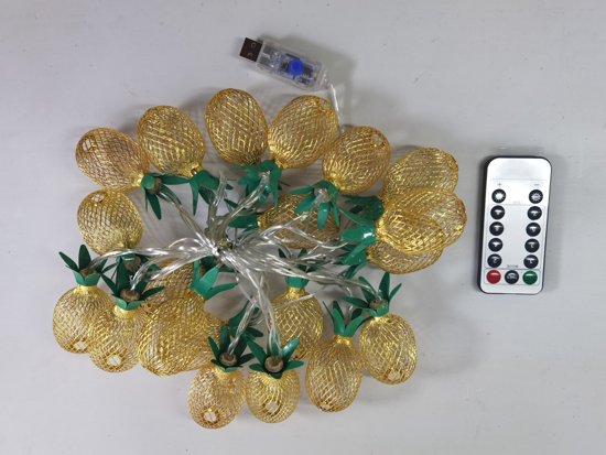 String lights with pineapple design, USB adapter, and remote control on a white background