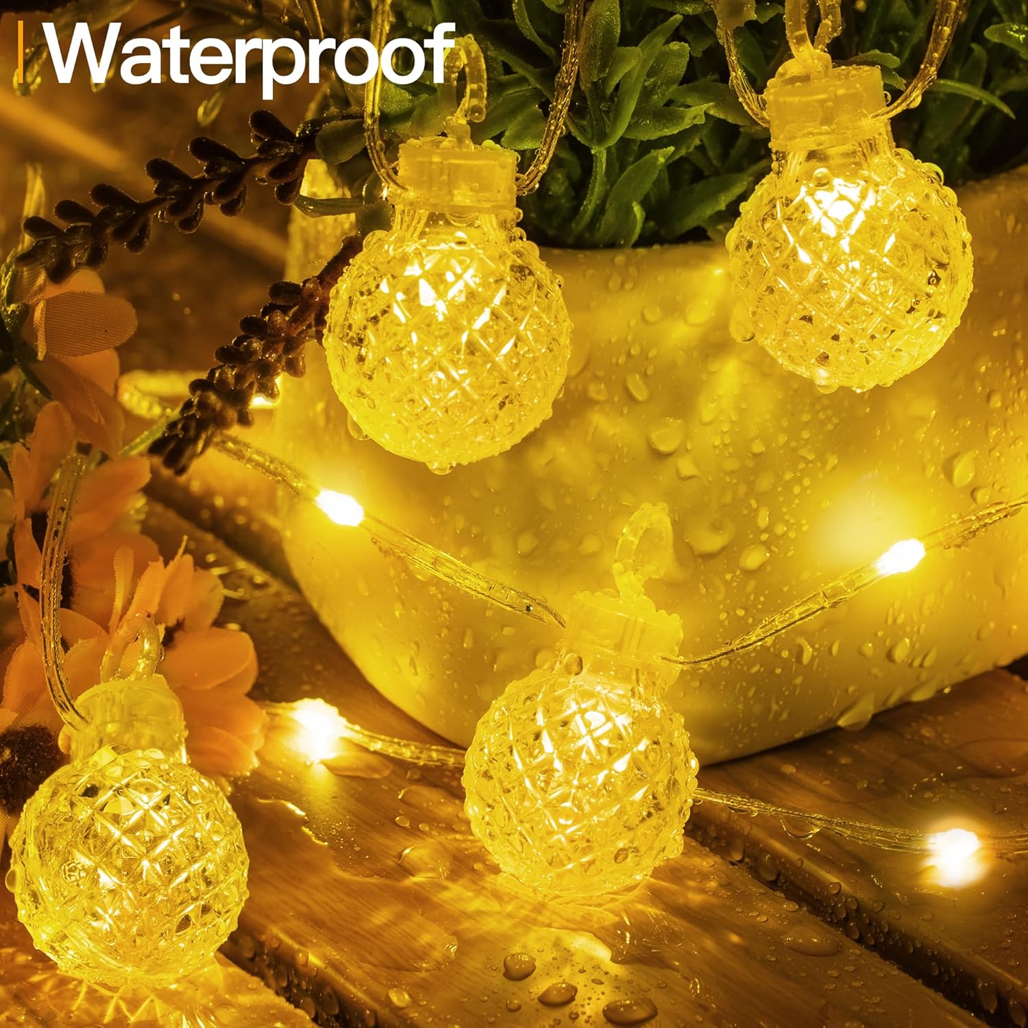 String lights with waterproof label on a decorative setting with flowers and a vase.