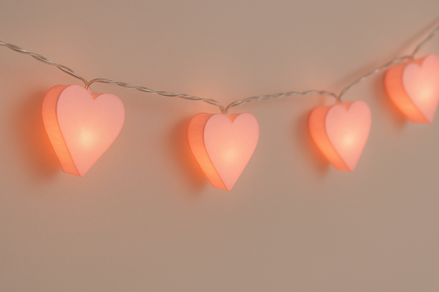 String of heart-shaped lights on a plain background