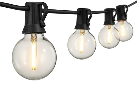 String of light bulbs on a black cord against a white background