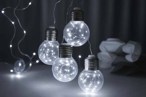 String of light bulbs with decorative lights on a dark background