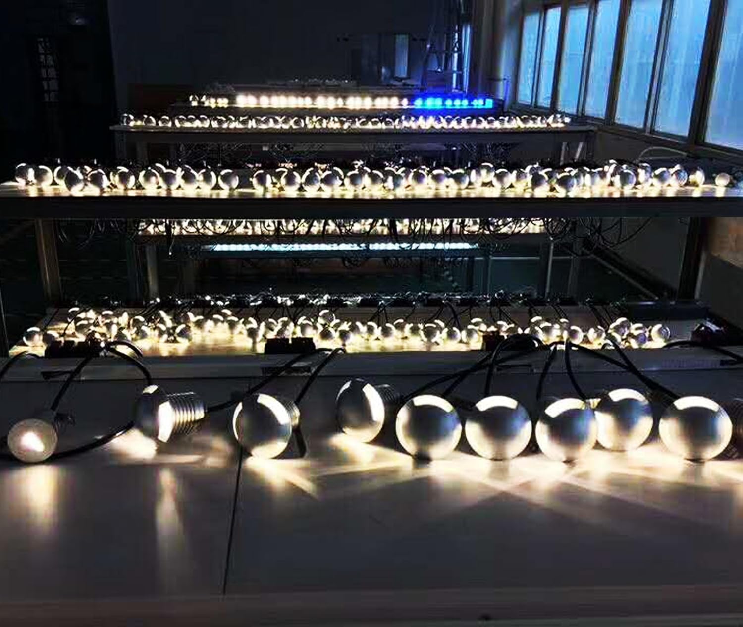 String of lights on a reflective surface with a blurred indoor background