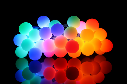 String of multicolored lights on a black background