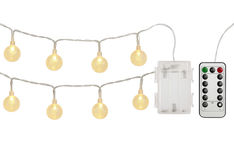 String of round lights with a remote control on a white background