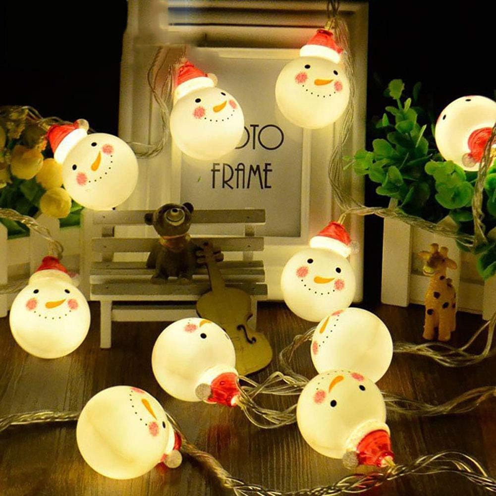 String of snowman-shaped lights on a wooden surface with a photo frame in the background.