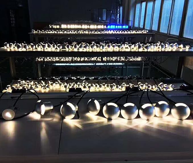 String of white light bulbs on a reflective surface with a blurred indoor background