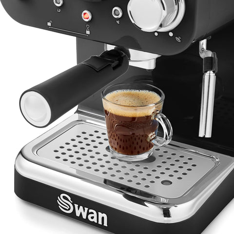 Swan espresso machine with a glass of freshly brewed espresso on a white background