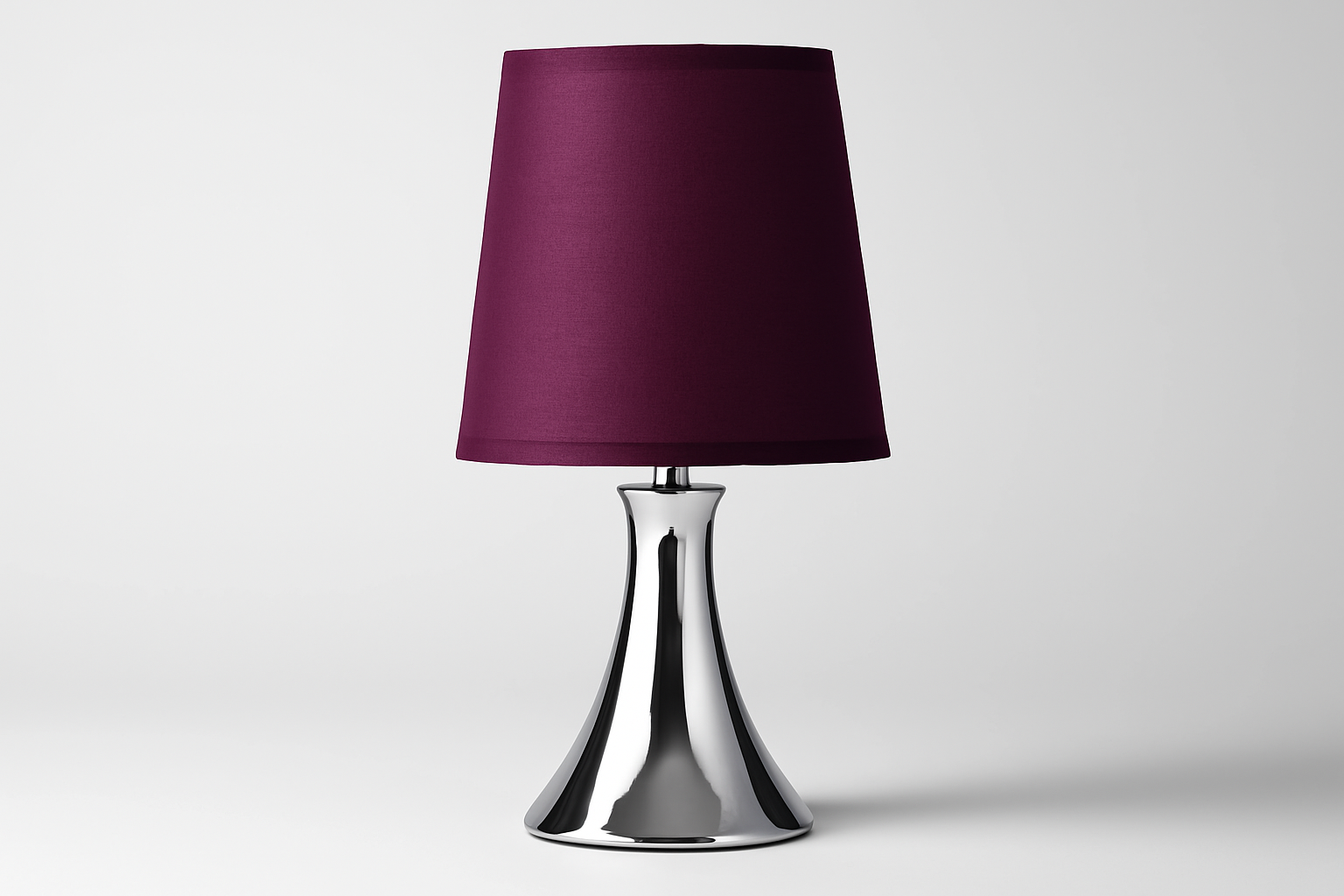 Table lamp with a purple shade and silver base on a white background