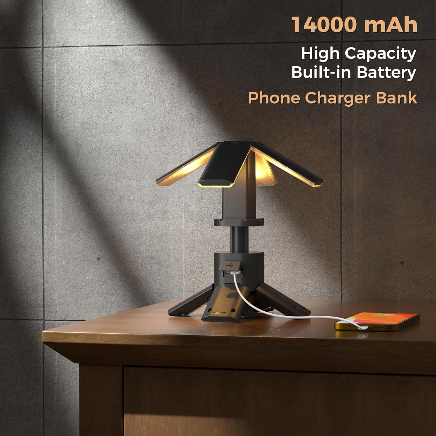 Table lamp with phone charging feature on a wooden surface against a gray wall.