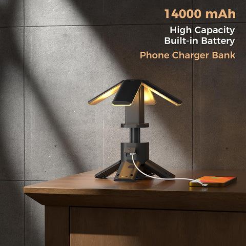 Table lamp with phone charging feature on a wooden surface against a gray wall.