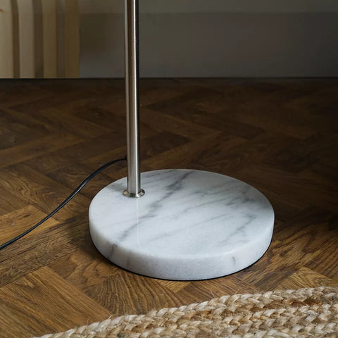 Copper lamp holder adding a touch of sophistication to the floor lamp.​

