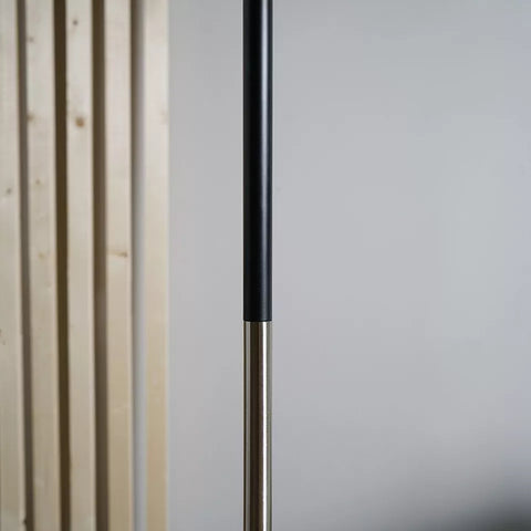 Tall industrial floor lamp enhancing the ambiance of a contemporary office.​

