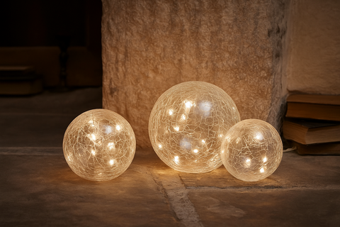 Three glowing spherical lights on a stone surface