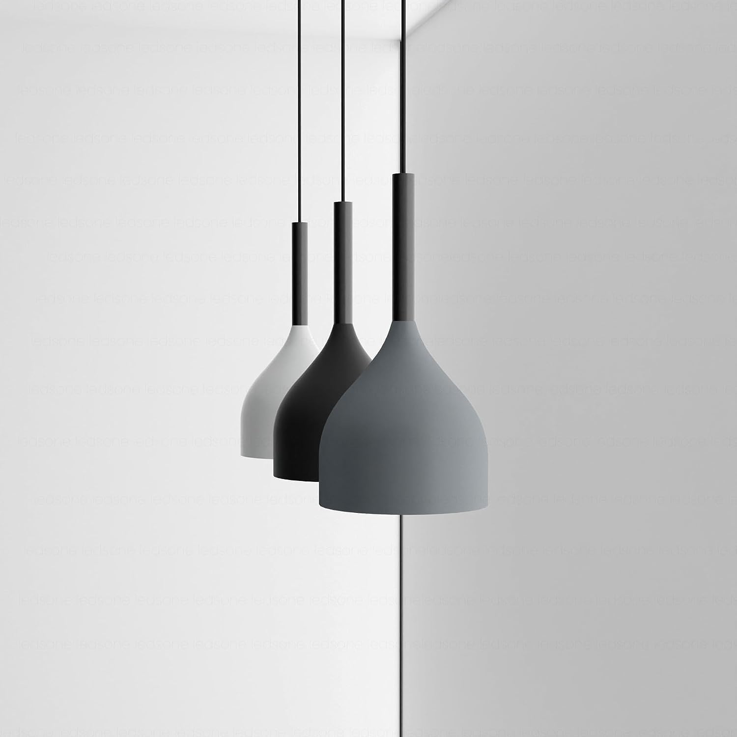 Three modern pendant lights hanging against a white background