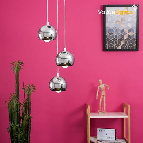 Three silver pendant lights hanging against a pink wall with a 'ValueLights' poster.