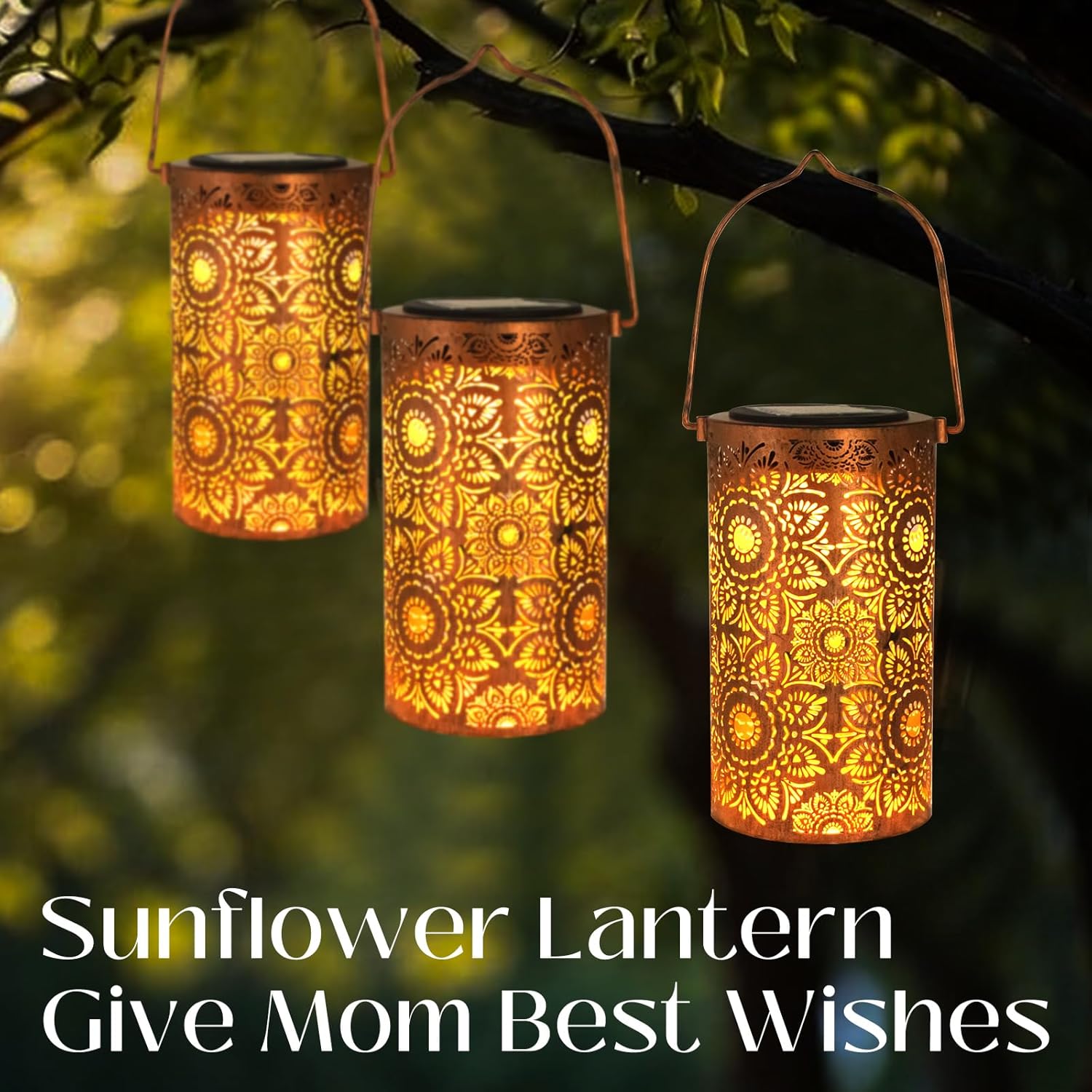 Three sunflower lanterns hanging from a tree branch with a blurred green background.